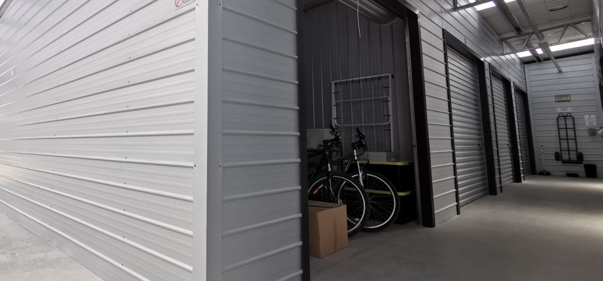 storage units, with the shutter to one being open and inside two bikes in view